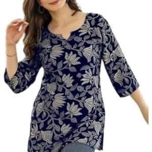 Woman wearing a white printed cotton kurti top with colorful geometric patterns, paired with blue jeans in an indoor setting.